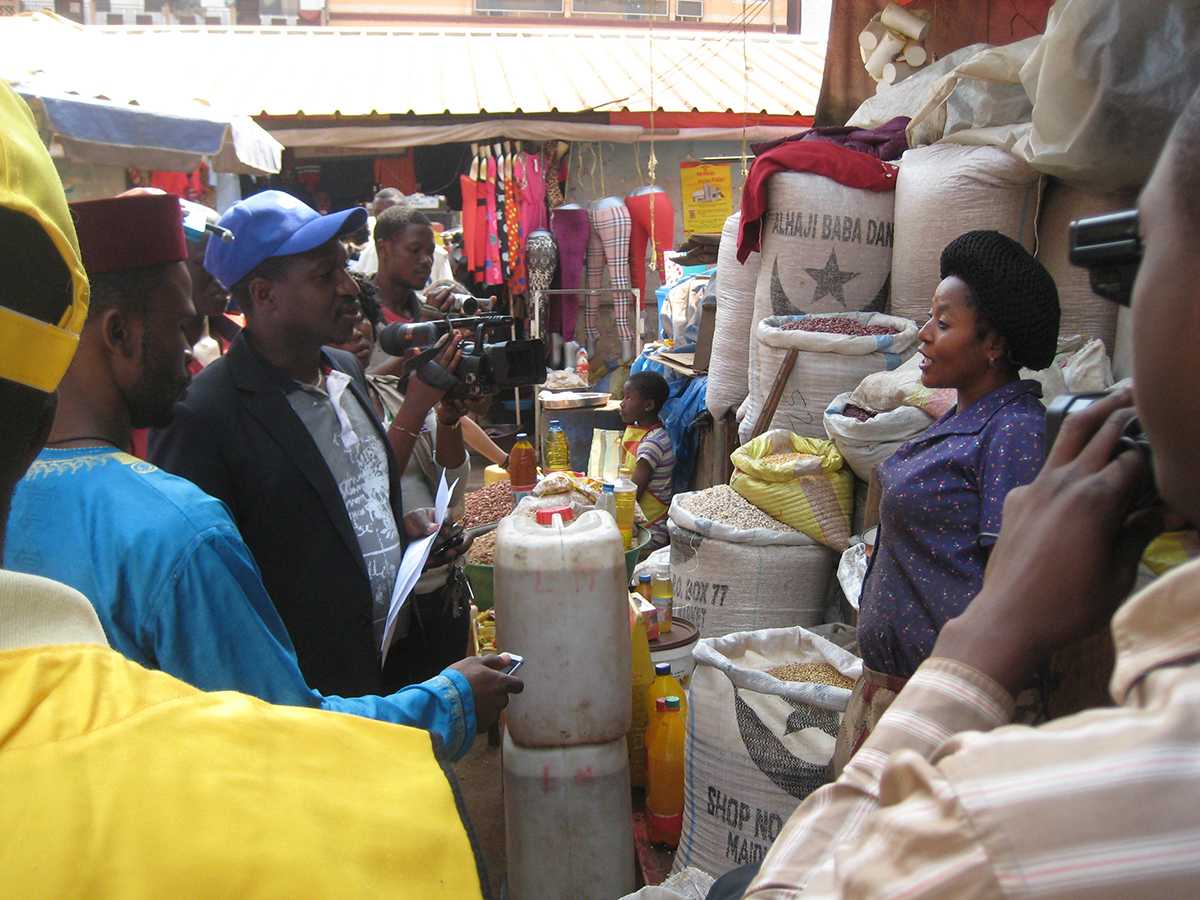 Cameroon: The social mobilization team promoting the campaign with a trader in a market place in Bamenda, North West region.