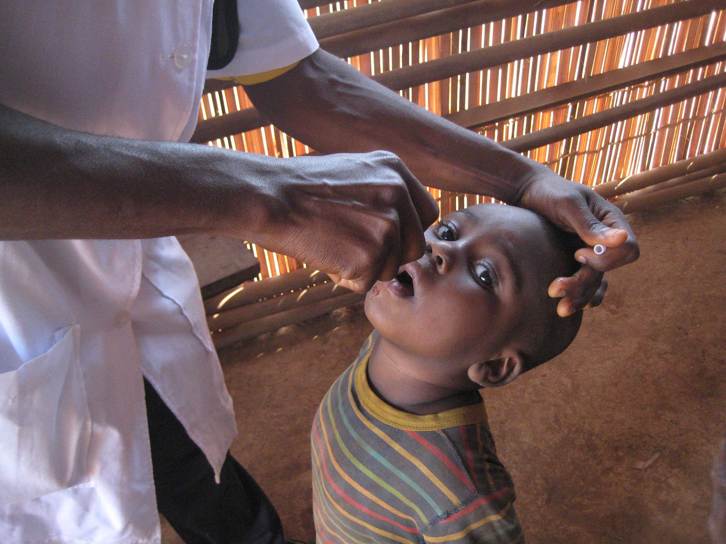 Cameroon: This child looks on as he receives his dose of the oral polio vaccine in the North West region of Cameroon.