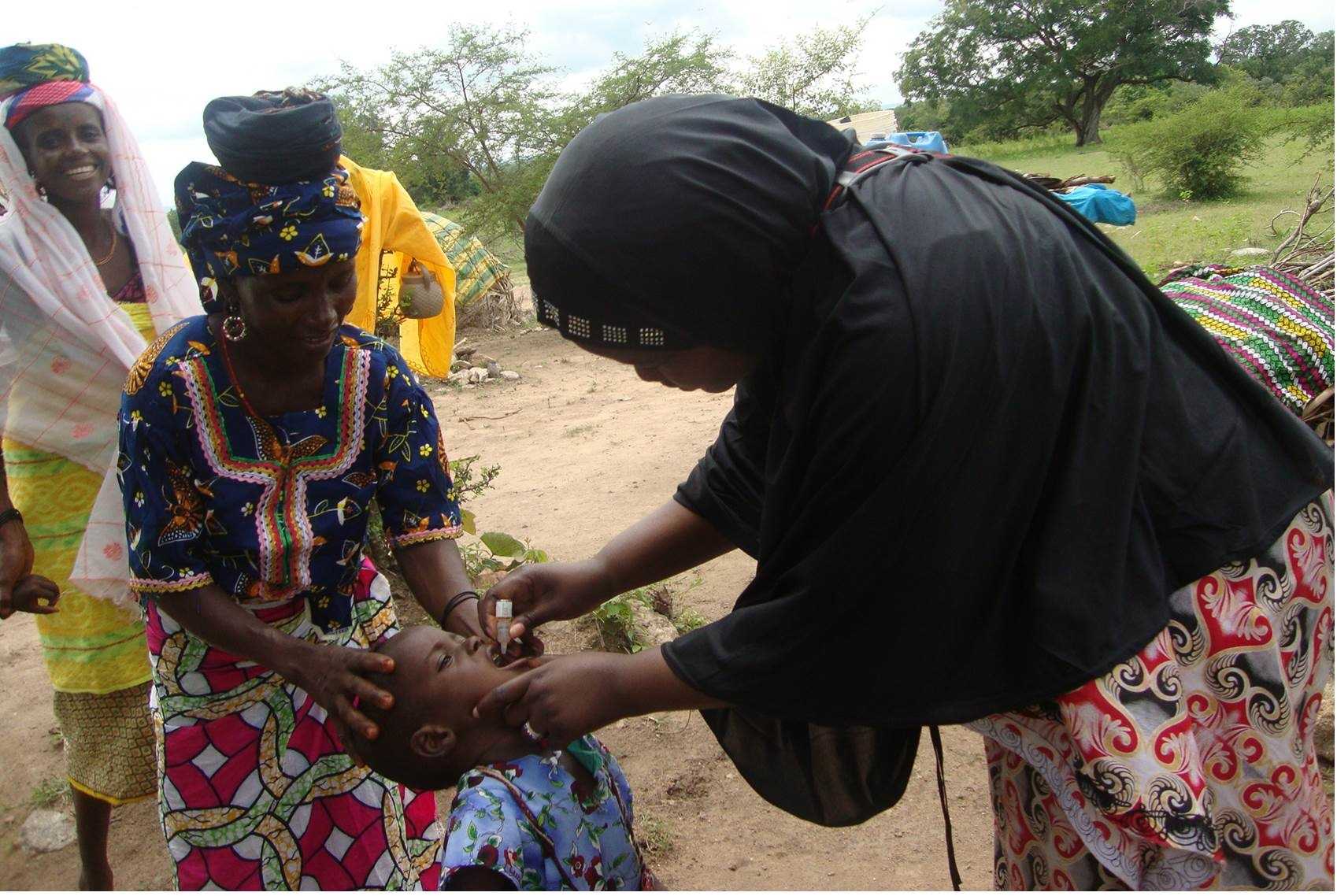 N-STOP officer giving 2 drops of oral polio vaccine to a child in a nomadic settlement in Bauchi State