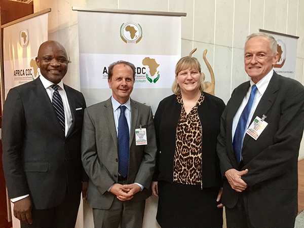 CDC Center for Global Health (CGH) former directors Dr. Tom Kenyon and Dr. Kevin De Cock pose with current CGH Director Dr. Rebecca Martin and Africa CDC Director Dr. John Nkengasong. 