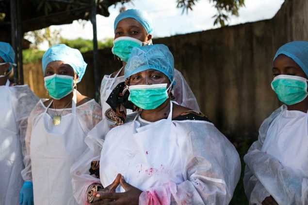 Public health workers learn how to use personal protective equipment at a CDC facilitated training in Guinea. (Photo credit: Patrick Adams/RTI International)