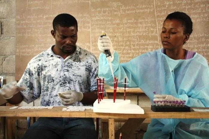 In this image, created in February, 2015, by Centers for Disease Control and Prevention (CDC) Epidemic Intelligence Service (EIS) Officer, Alaine Kathryn Knipes, Ph.D., two laboratory technicians with Haiti’s ministry of health (MoH), Mr. Dorelus and Mrs. Byzette, were processing blood samples in order to test for lymphatic filariasis (LF) and malaria, using rapid diagnostic tests in a rural classroom located in the Nippes Department of Haiti. This was one of the entries in the 2015 CDC Connects, Public Health in Action Photo Contest.