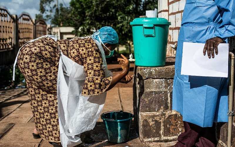 A health worker washes her hands outside a training on infection prevention and control practices.