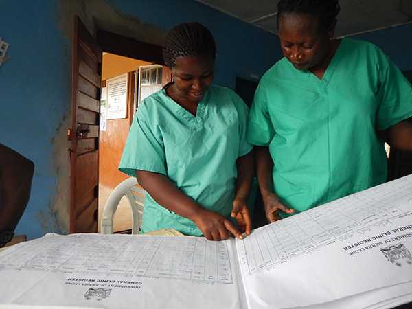 	Community health workers review reports from a health facility in Kambia district