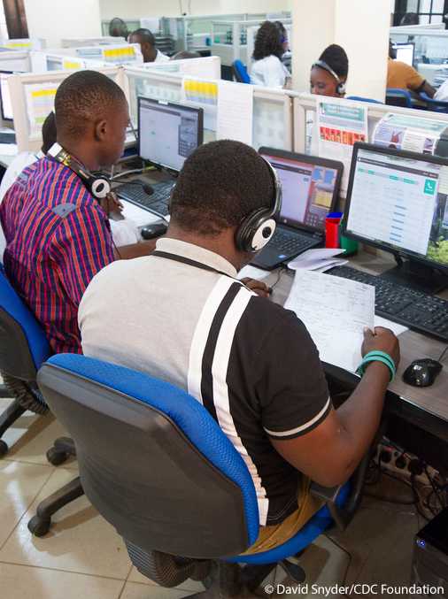 Freetown, Sierra Leone - The 7-1-1 section of the 1-1-7 call center at the AFCOM building in Freetown. The 7-1-1 number is used for Ebola vaccine trial participants, while the 1-1-7 number is the national Ebola hotline. The CDC Foundation provides support to both centers