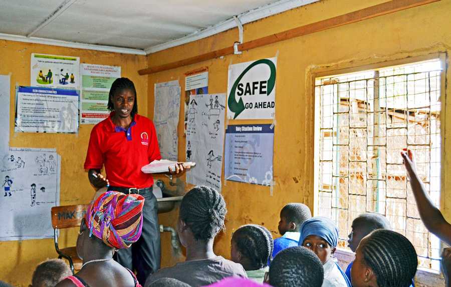 	A staff from LVCT Health, a CDC Kenya partner, provides evidence-based health education and HIV prevention classes to young people in Korogocho.