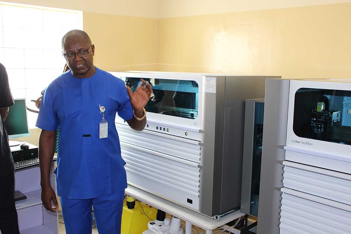 Mr. Chinwe Christopher Ifeanyi, Program Manager, Molecular Diagnostics Unit, Clinical Laboratory Services Department, IHVN; explaining the uses of the newly installed PCR machines to dignitaries that graced the commissioning ceremony