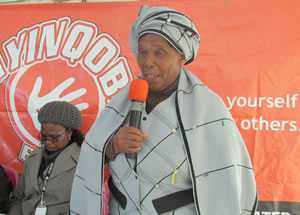 A traditional healer encourages people to step forward and test for HIV.
