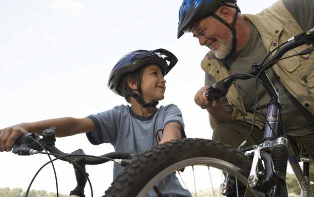 	photo: father and son riding bikes with helmets