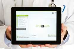 image of a doctor holding a tablet with the HEADS UP to Clinicians training