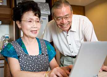 	Photo of an elderly couple looking at a laptop computer