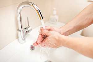 A person washing hands.