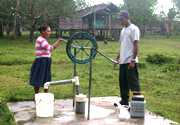 	A couple pumps water out of a community well