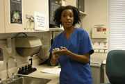 Photo of a nurse demonstrating hand hygiene techniques (excerpted from video).