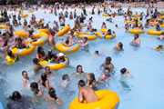 Crowded wavepool with swimmers and inner tubes.