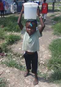 Photo: Child with water bucket on head
