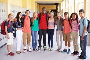 Group Of High School Students Standing In Corridor 