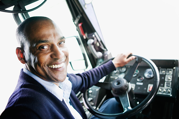 phot of a man in the driver's seat of a bus