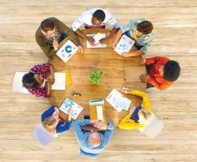 Overhead photo of a group working at a circular table.