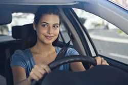 Photo: Young woman driving a car
