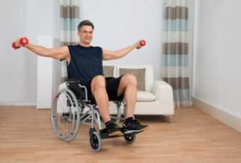 image of a man in a wheelchair lifting arm weights