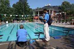 	aquatics professionals testing the pool chemicals by the side of the pool