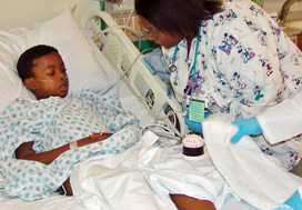 Mohammad Adisa in the Pediatric Intensive Care Unit, being treated for severe malaria. (Courtesy John Easton, University of Chicago Hospitals)
