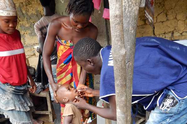 Young girl getting vitamin A supplement during measles and polio vaccination drive. CDC photo