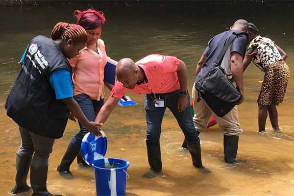Liberian disease detectives taking water samples during a shigellosis outbreak investigation in Grand Bassa County.