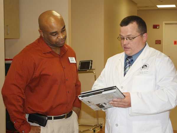 A physician and health care worker review an electronic screening system used at the Community Cancer Screening Program. The Cancer Coalition of South Georgia used Task Force recommendations to help develop a cancer screening program for breast, cervical and colorectal cancers. The programâ€™s goal is to reduce cancer-related disparities in medically underserved Baker County. The program pilot started in Baker County and expanded to 12 primary care clinics serving more than 25 counties in South Georgia.