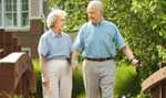 Elderly couple walking over a bridge
