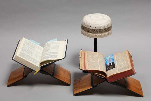 The Qur’an and Bible are sitting on traditional hand-carved rehals