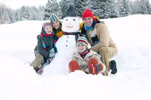 Family building a snowman
