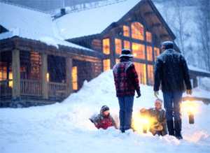 Family in front of a house covered in snow