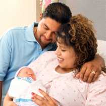 Two parents with a newborn baby
