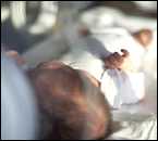 An infant laying in a hospital bed