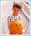 Boy Holding a Pumpkin