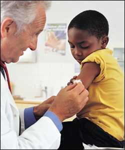 A doctor administers a flu vaccine to a boy