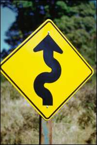 Road sign warning of upcoming curves