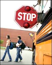 Students crossing in front of a school bus