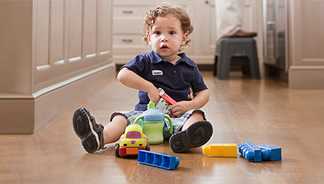 A little boy playing with toys on the floor
