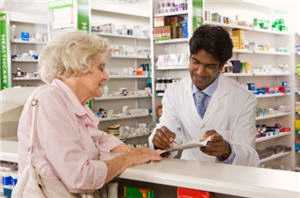 	woman at pharmacy getting a prescription