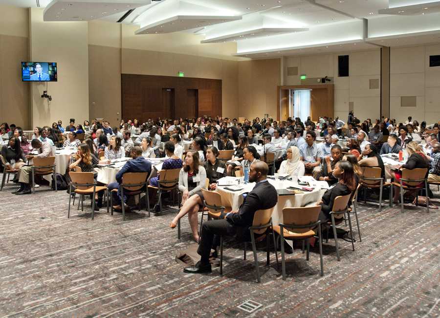 students seated at tables in the orientation