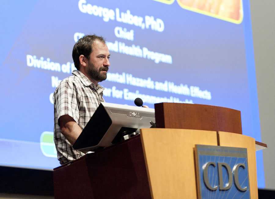 George Luber, PhD, at podium during presentation