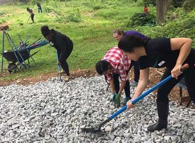 group of young professionals working at a community service activity