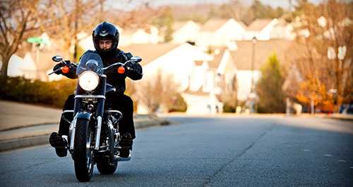 Photo: man riding a motorcycle wearing a helmet