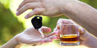 photo: someone with a drink handing over the car keys