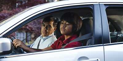 photo: teen son and father in a car