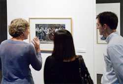 Visitors discuss a photograph in the David J. Sencer CDC Museum’s Temporary Gallery.