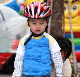 A young boy in a bike helmet